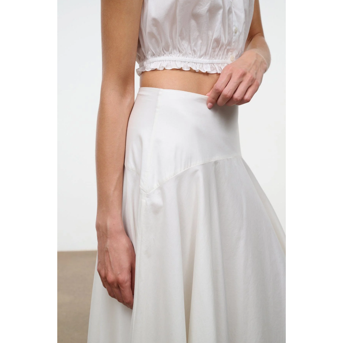 White top and skirt set on a plain background