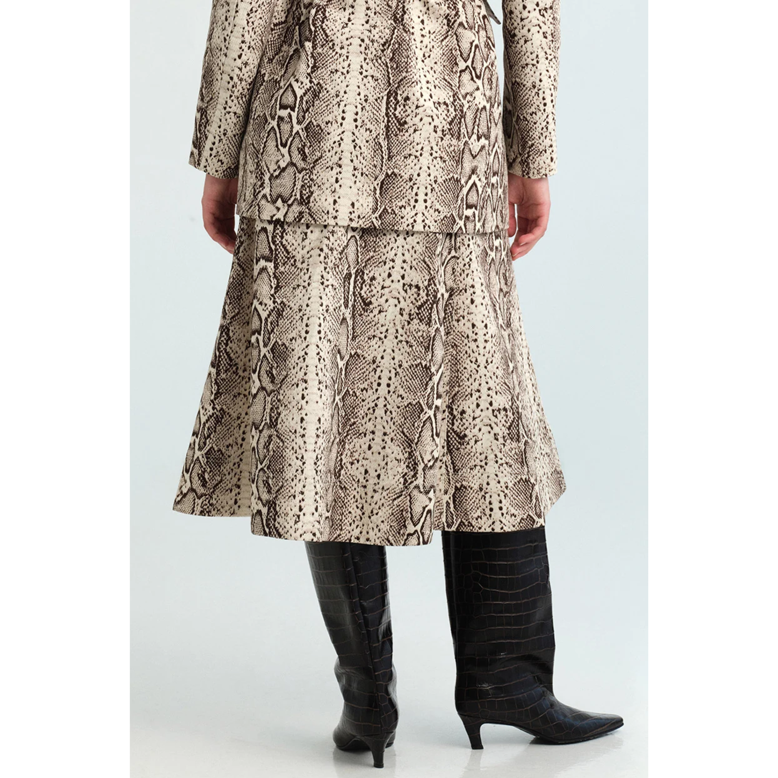 A mid-length A-line skirt featuring a beige and brown snakeskin pattern, displayed on a clean white background.
