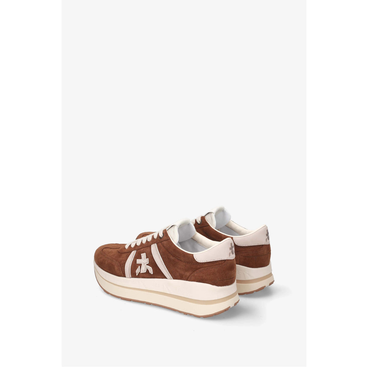 A pair of brown suede low-top sneakers with white leather side stripes, white laces, and a thick cream-colored sole, shown from a three-quarters angle against a light gray background.
