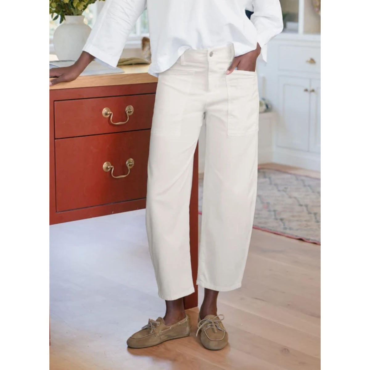 Mid-section close-up of a model wearing the Frank & Eileen Bray Everyday Barrel Pant in Chalk, showing the high-waisted waistband, front button closure, and pocket detailing.