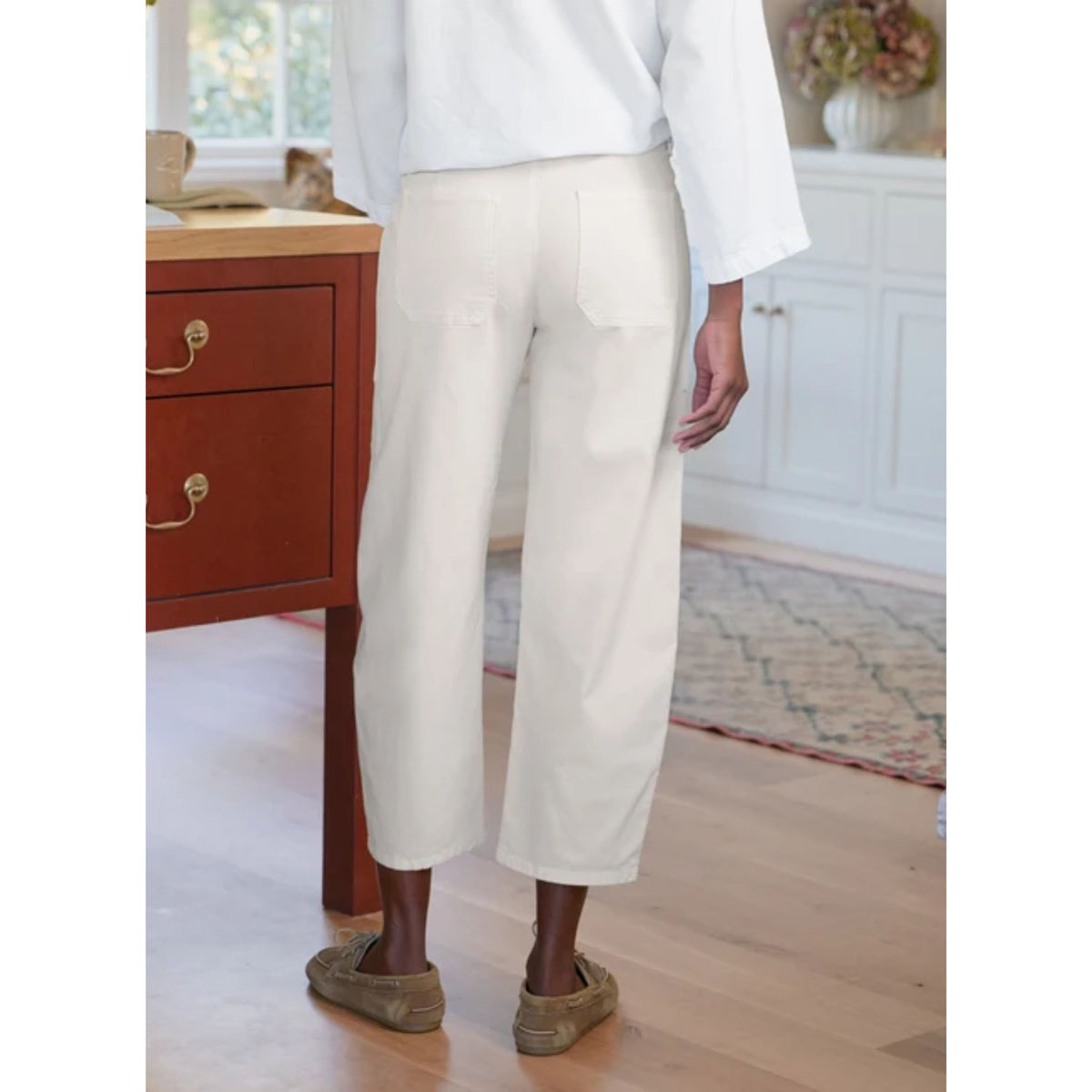 Full-length front view of a model wearing the Frank & Eileen Bray Everyday Barrel Pant in Chalk paired with a matching white top and brown leather shoes in an indoor setting.