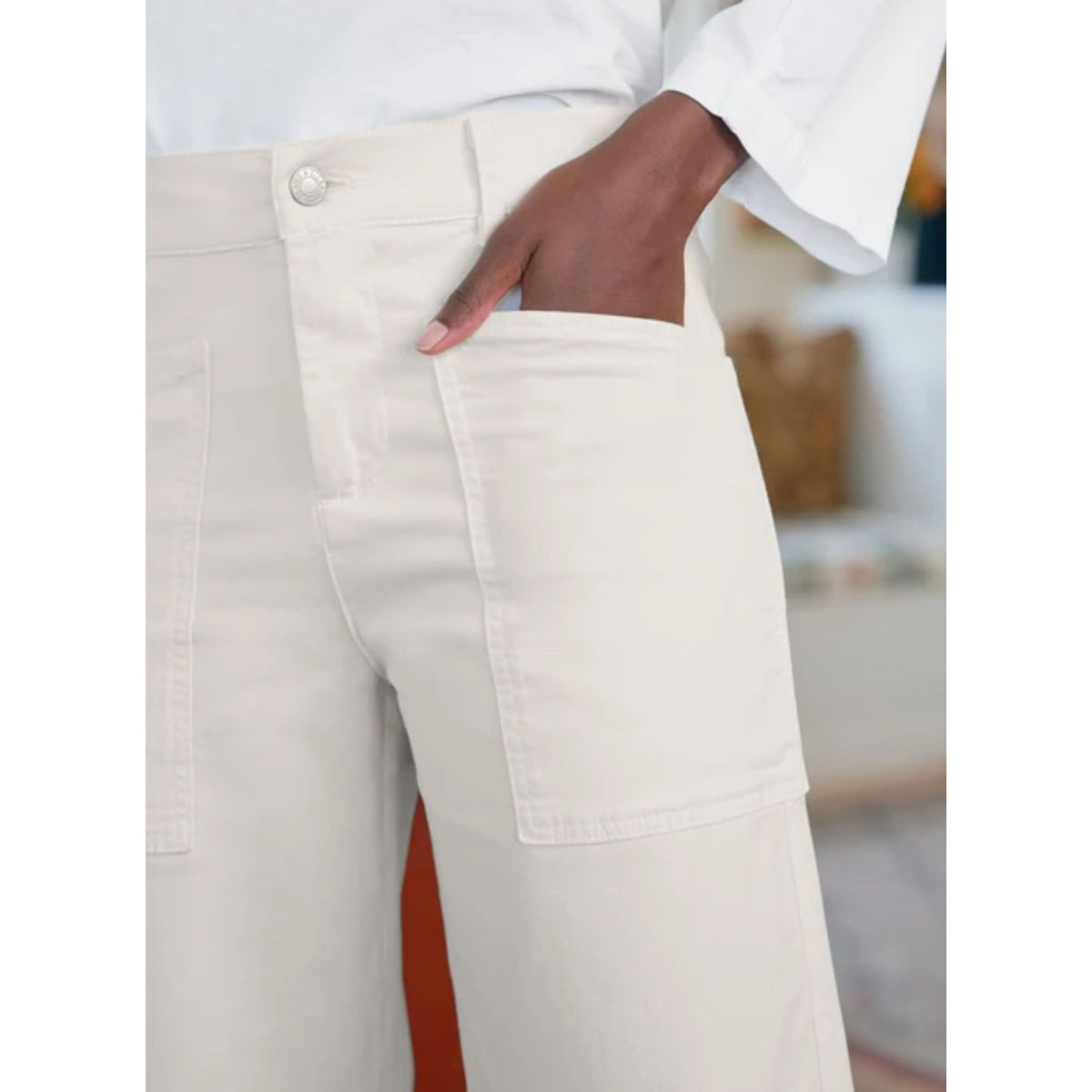 Full-length side profile view of a model wearing the Frank & Eileen Bray Everyday Barrel Pant in Chalk paired with a matching top and brown shoes indoors.