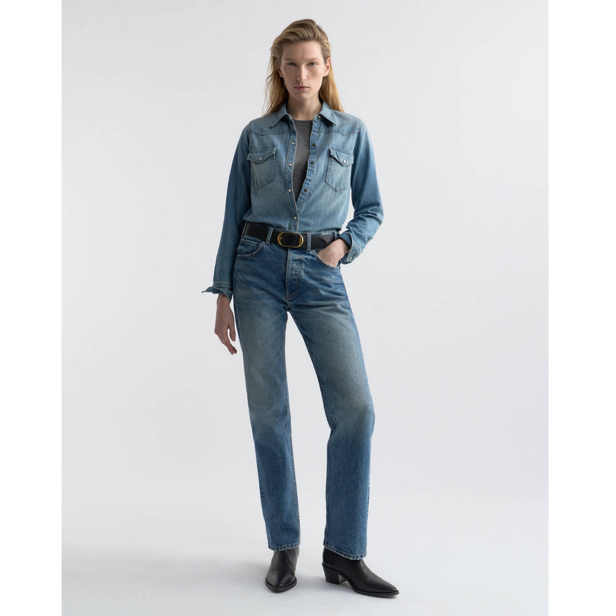 Person wearing a denim outfit on a white background