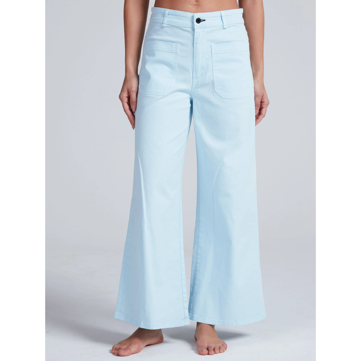 Light blue jeans worn by a person on a plain background