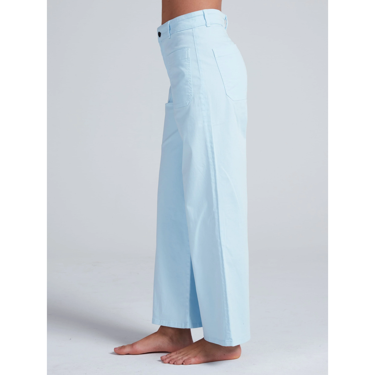 Light blue pants worn by a person on a white background