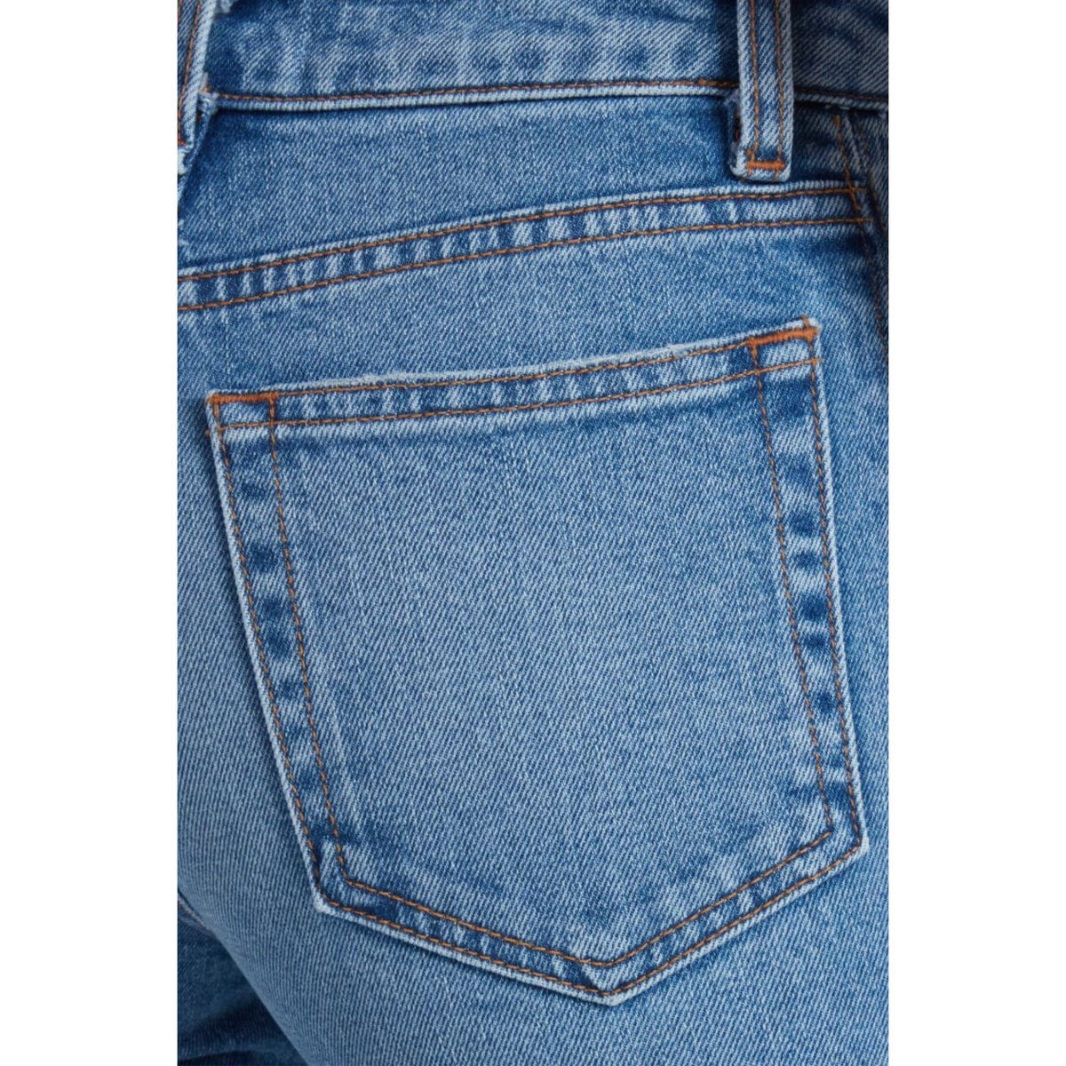 Close-up of the back pocket of light blue denim jeans, showing the fabric texture, stitching, and contrast orange-brown thread details.
