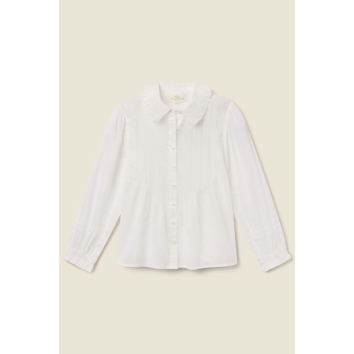 A white long-sleeve button-up blouse with a Peter Pan collar, shown flat against a light beige background.