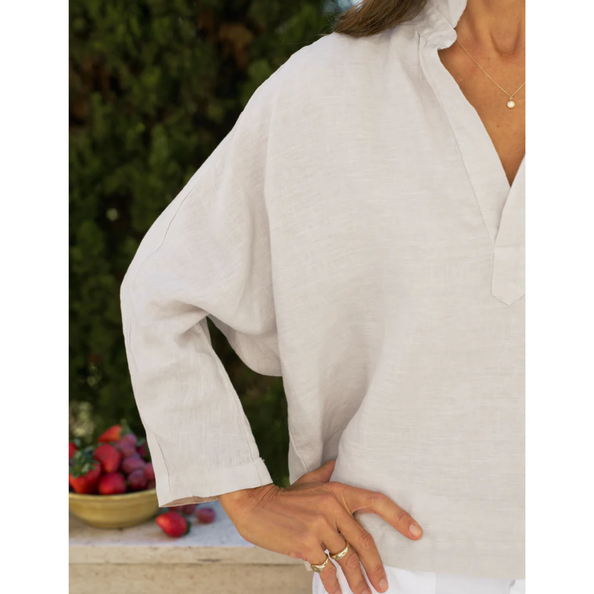 Person wearing a white shirt with a blurred background