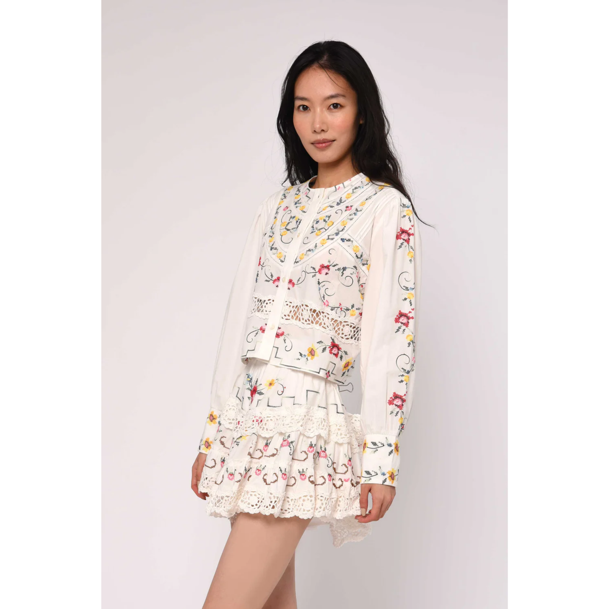 Woman wearing a floral dress on a plain background