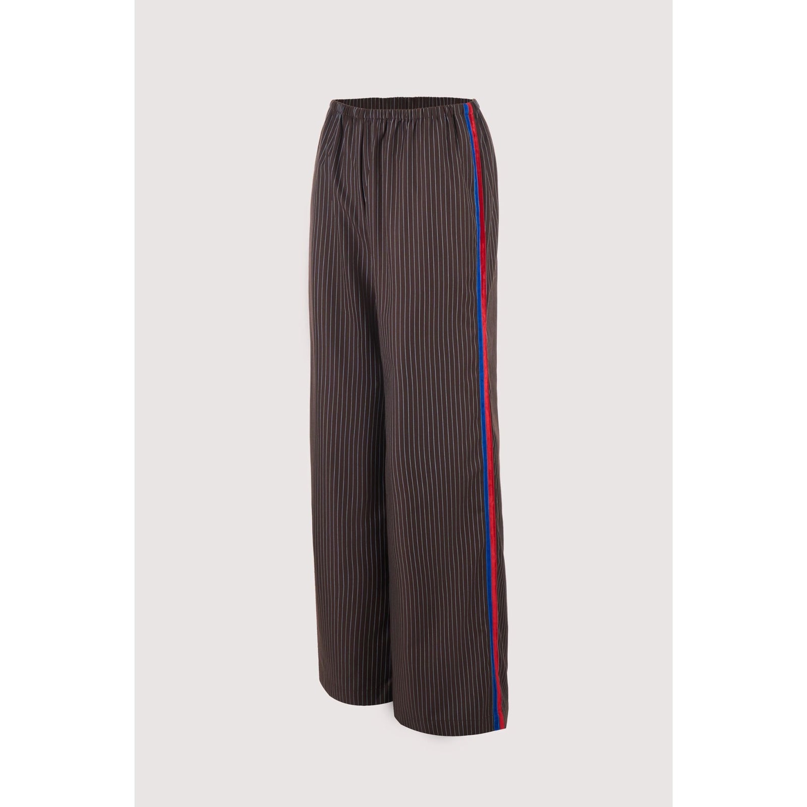 A pair of dark brown wide-leg trousers with thin vertical pinstripes and a red and blue stripe down the side, shown against a light gray background.