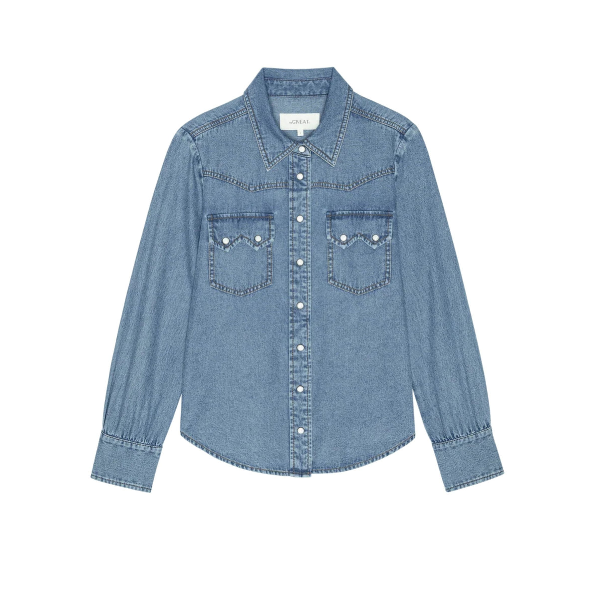 A light blue denim long-sleeve button-up shirt with two buttoned chest pockets, photographed flat against a solid white background.