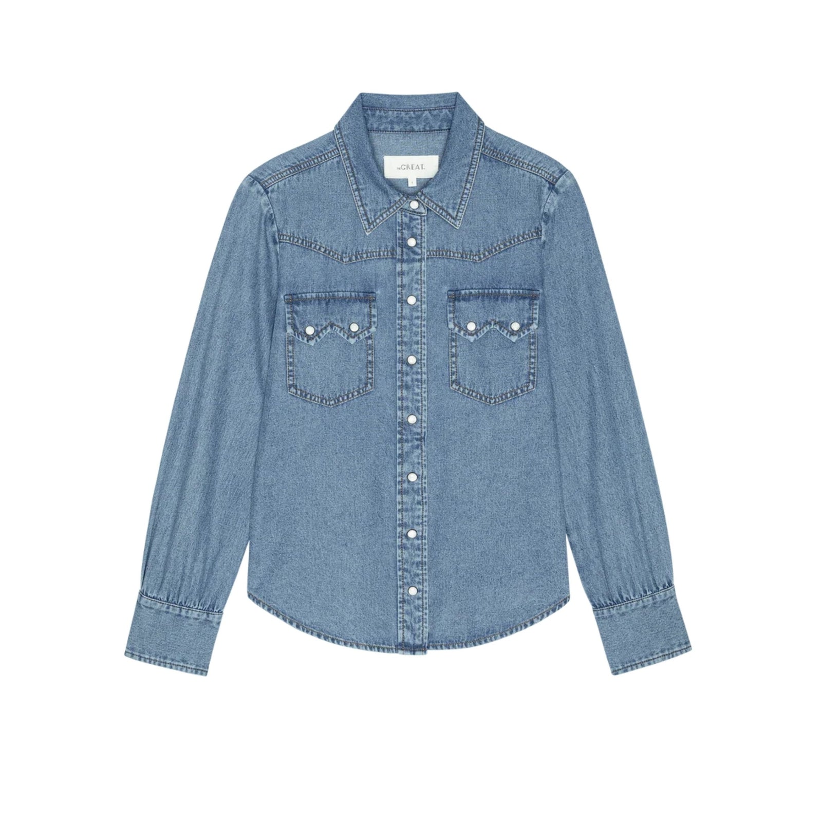 A light blue denim long-sleeve button-up shirt with two buttoned chest pockets, photographed flat against a solid white background.