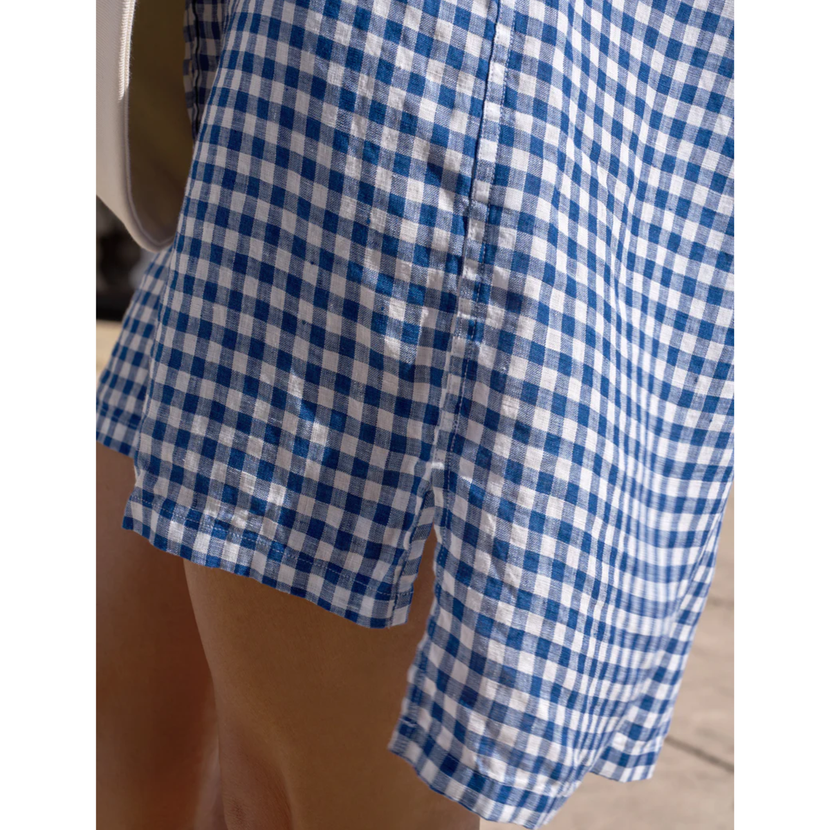 Blue and white checkered shorts on a plain background