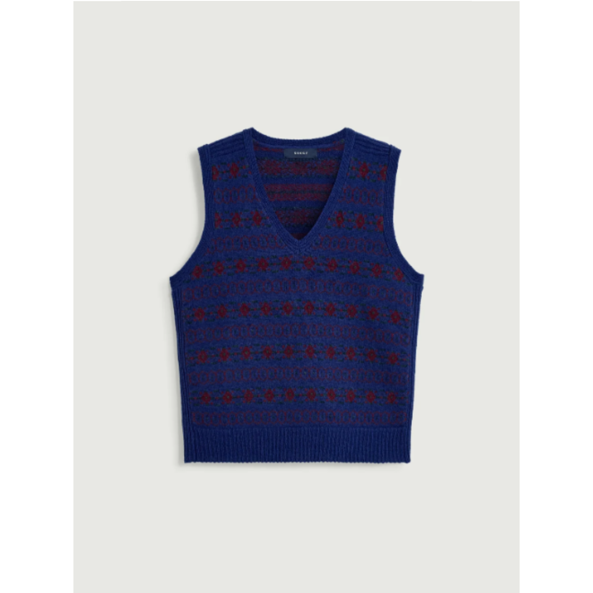 A sleeveless knit sweater vest in deep blue with a red geometric pattern, displayed flat against a light gray background.