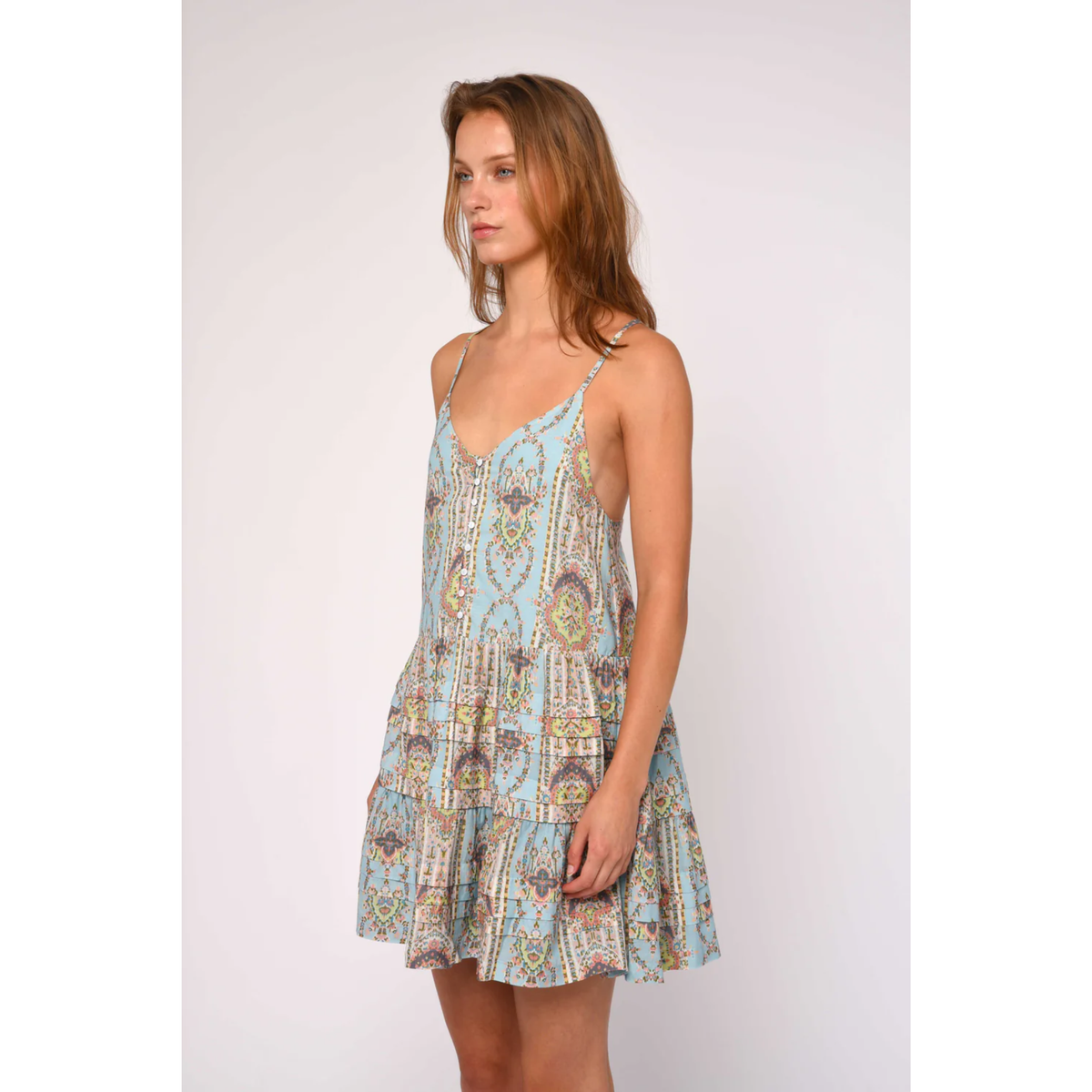 Woman wearing a patterned dress on a white background