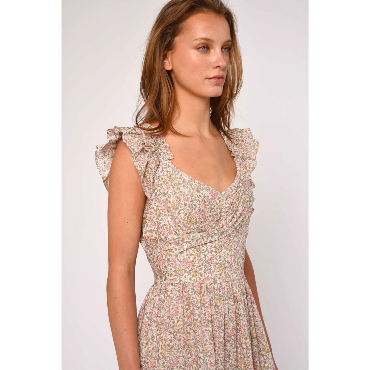 Woman wearing a floral dress on a plain background