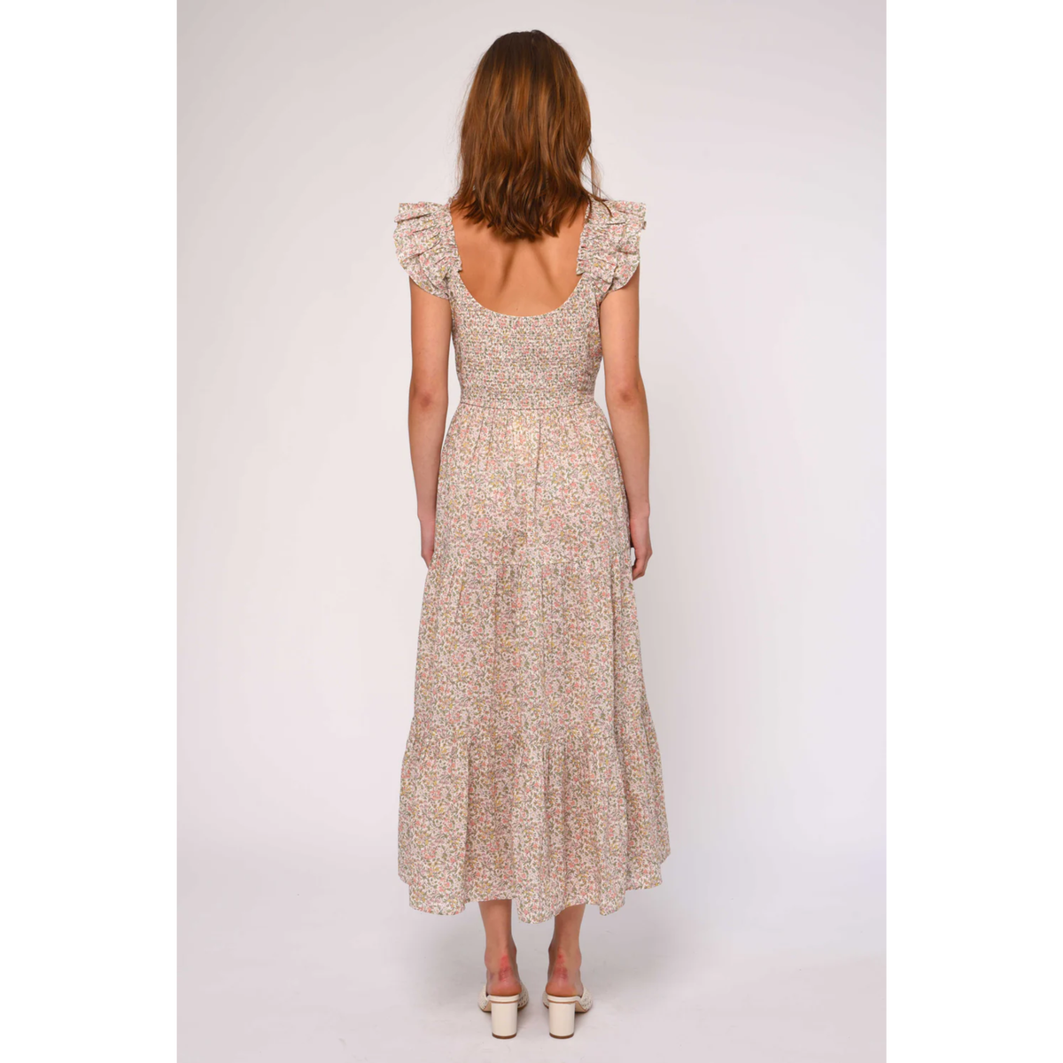Woman wearing a floral dress on a white background