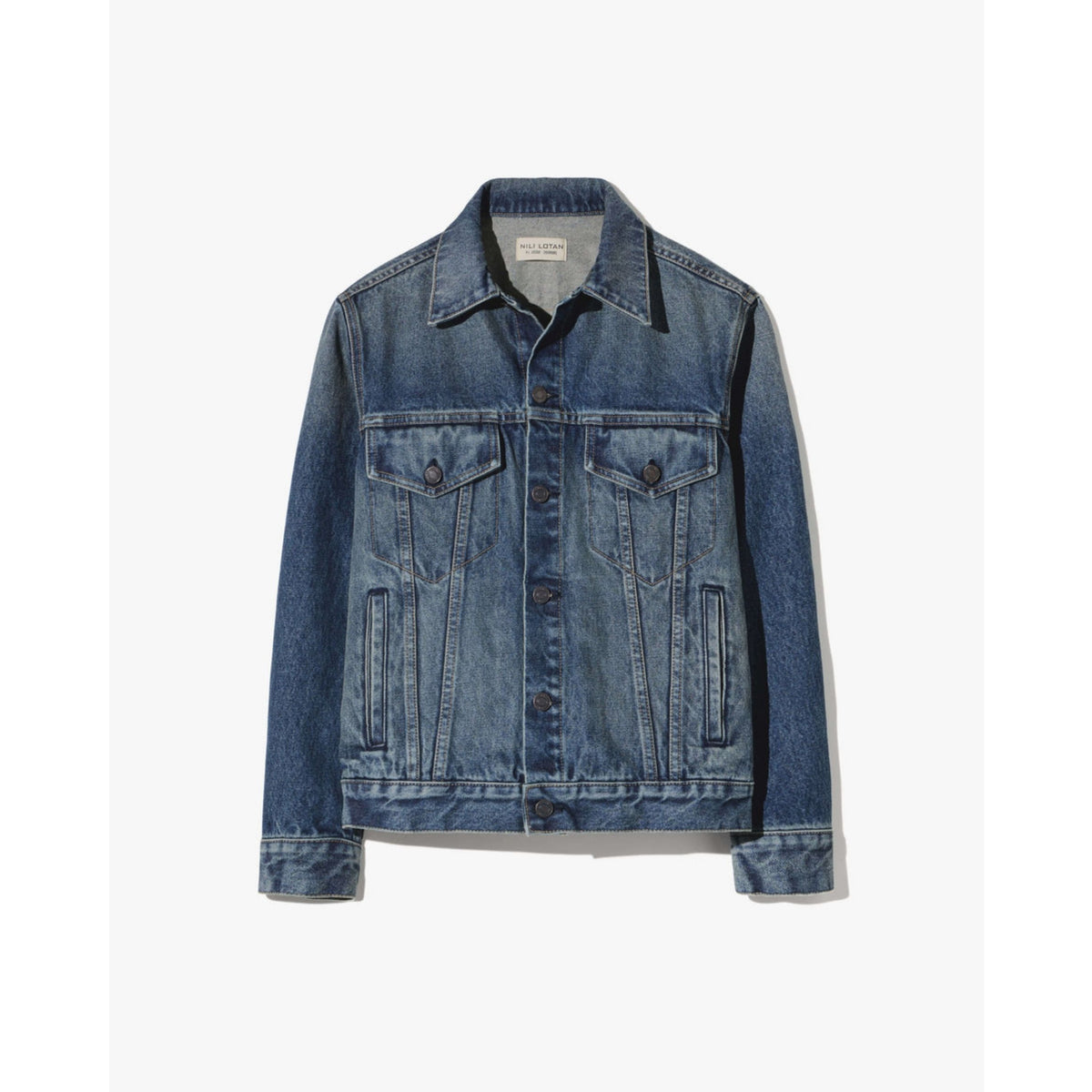 A classic blue denim jacket with a button-up front, two buttoned chest pockets, and two vertical welt pockets on the lower front, shown flat against a light off-white background.