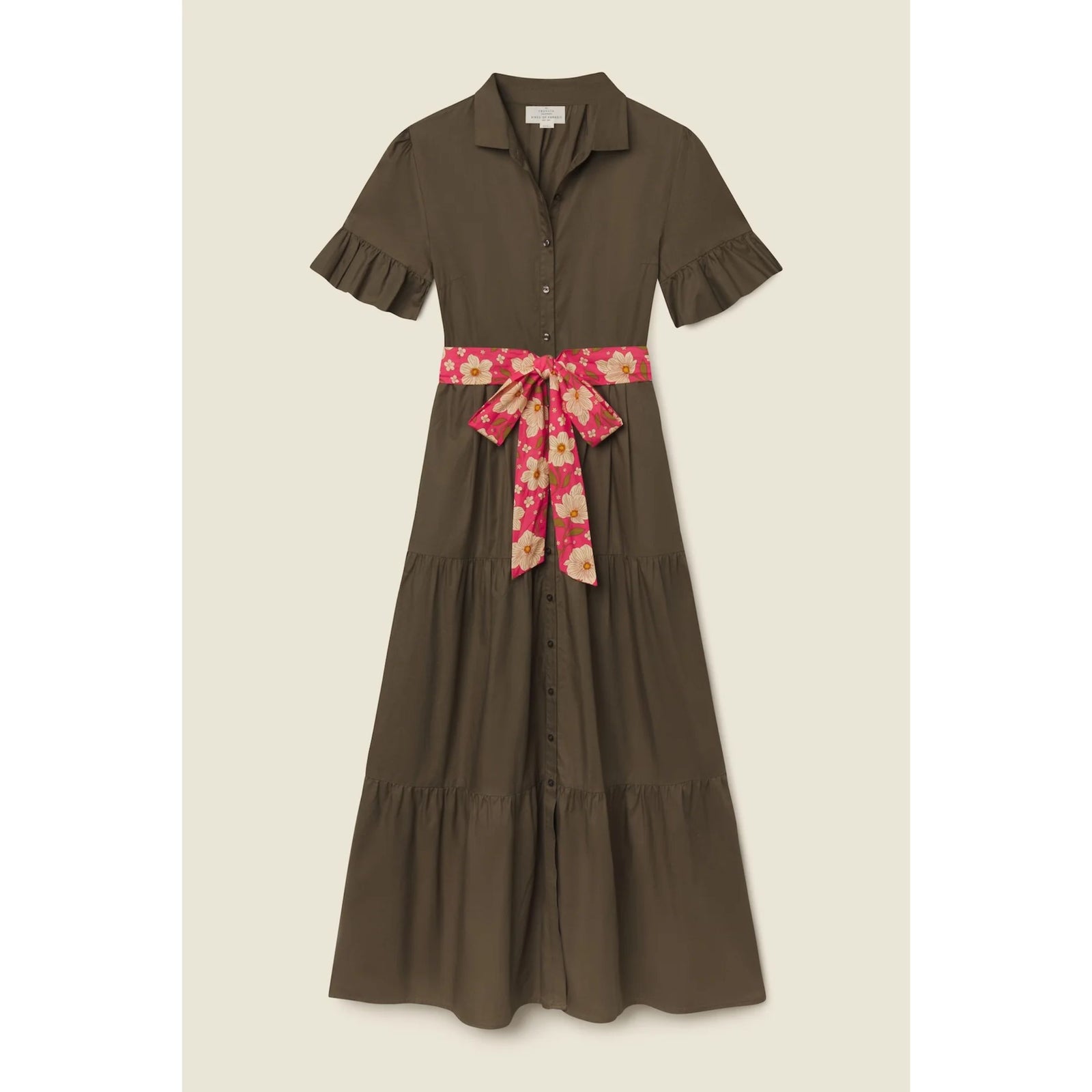 An olive brown short-sleeve midi dress with ruffled sleeves, a button-down front, and a pink floral waist tie belt, shown against a solid light beige background.
