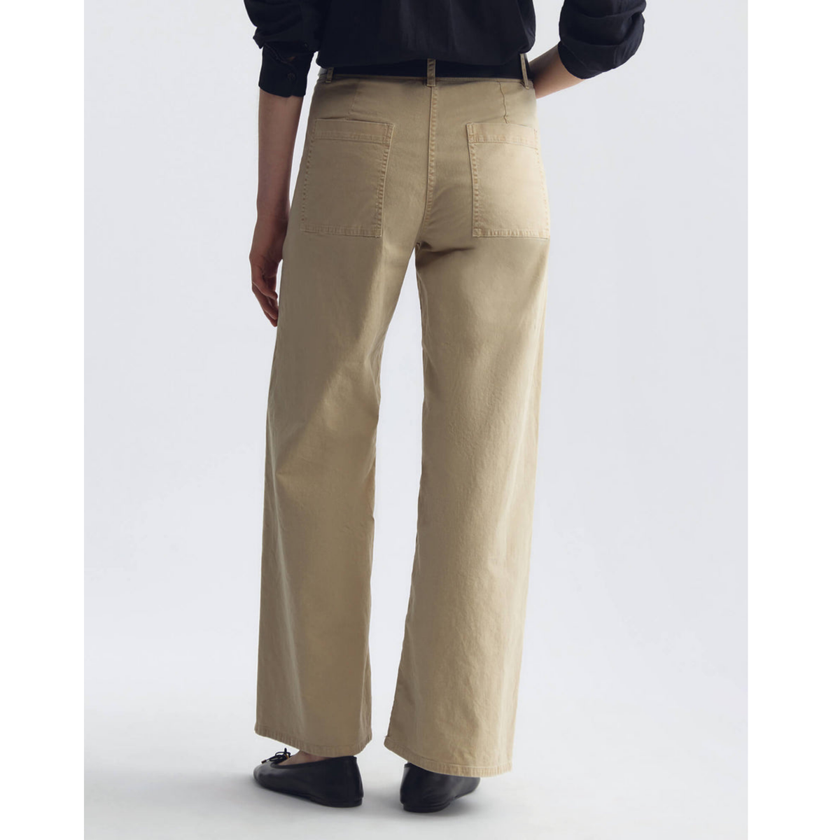 Beige wide-leg pants worn by a person on a white background
