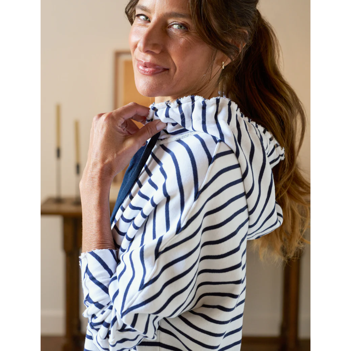 Woman wearing a white dress with blue stripes indoors