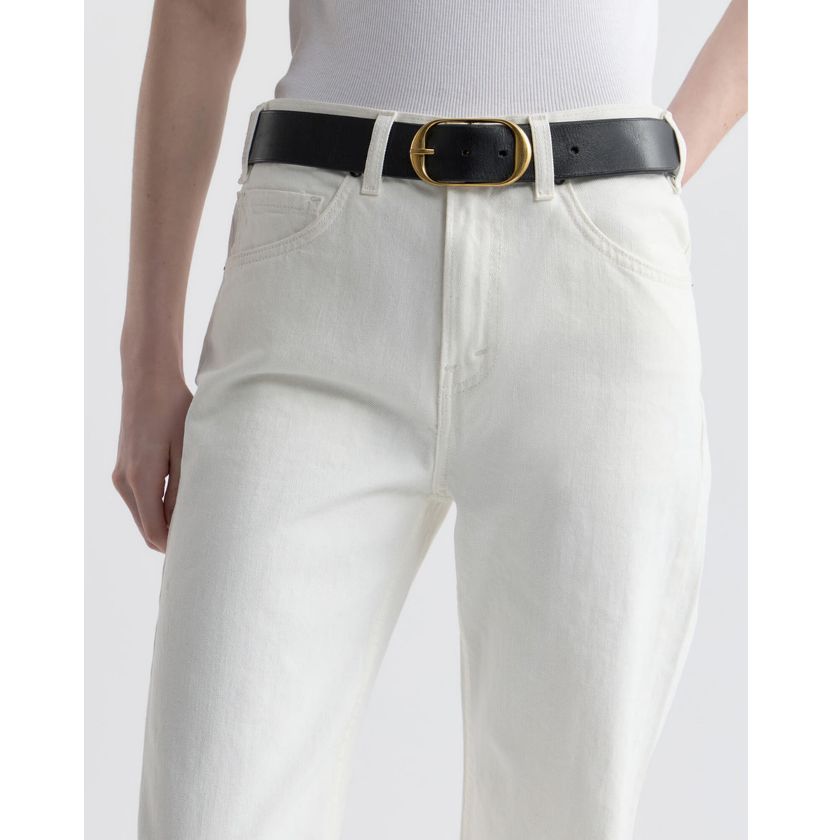 White jeans with a black belt and gold buckle on a white background