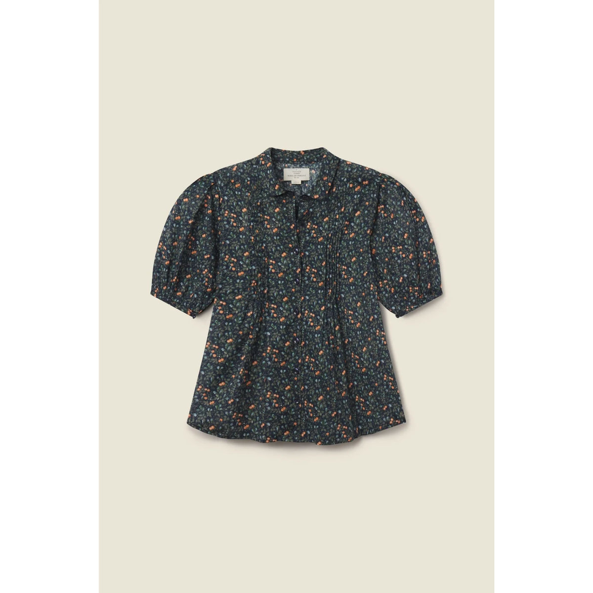 A short-sleeve blouse with a dark navy blue base and a dense orange and yellow floral print, featuring puff sleeves and a small bow at the collar, displayed flat against a light beige background.