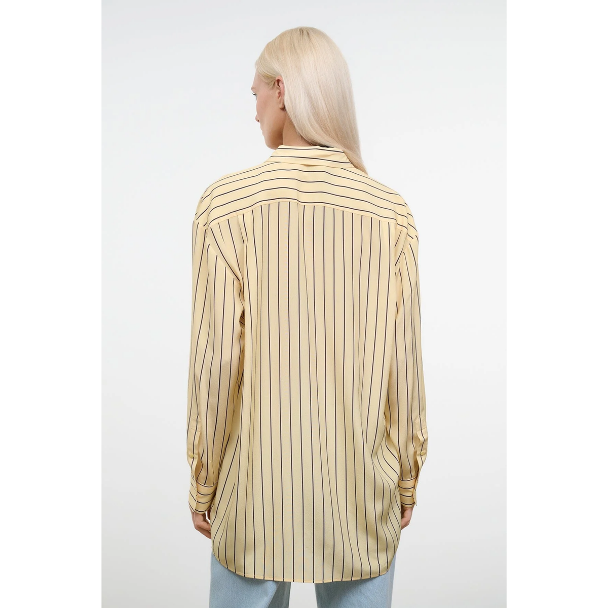 Person wearing a beige and white striped shirt on a white background