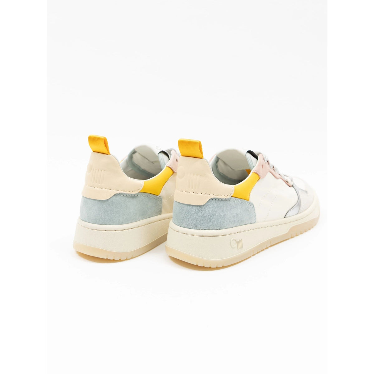 A pair of low-top sneakers shown from the back, featuring a white leather upper with light blue suede panels, a cream midsole, and bright yellow heel pull tabs.