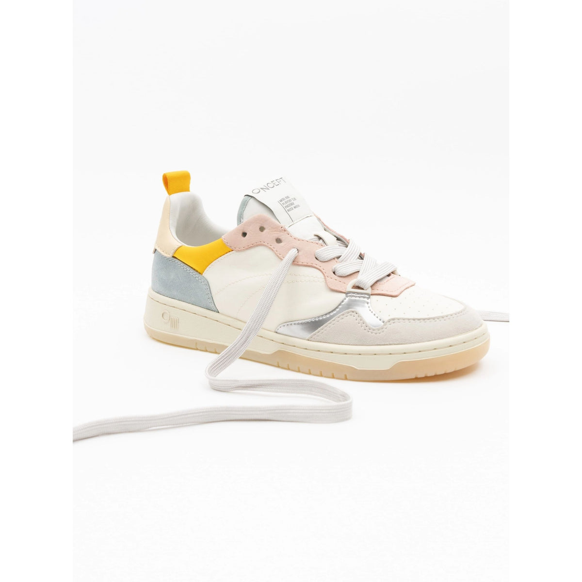 A low-top sneaker with a cream and white leather upper, featuring pastel pink and light blue color-blocked panels, a metallic silver side stripe, a yellow pull tab, and white laces.