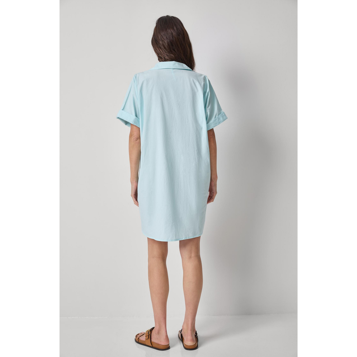 Light blue dress worn by a person on a plain background