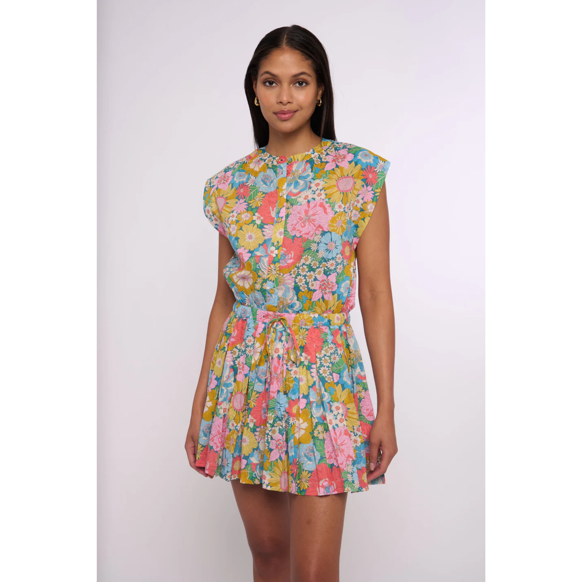 Woman wearing a colorful floral dress on a white background