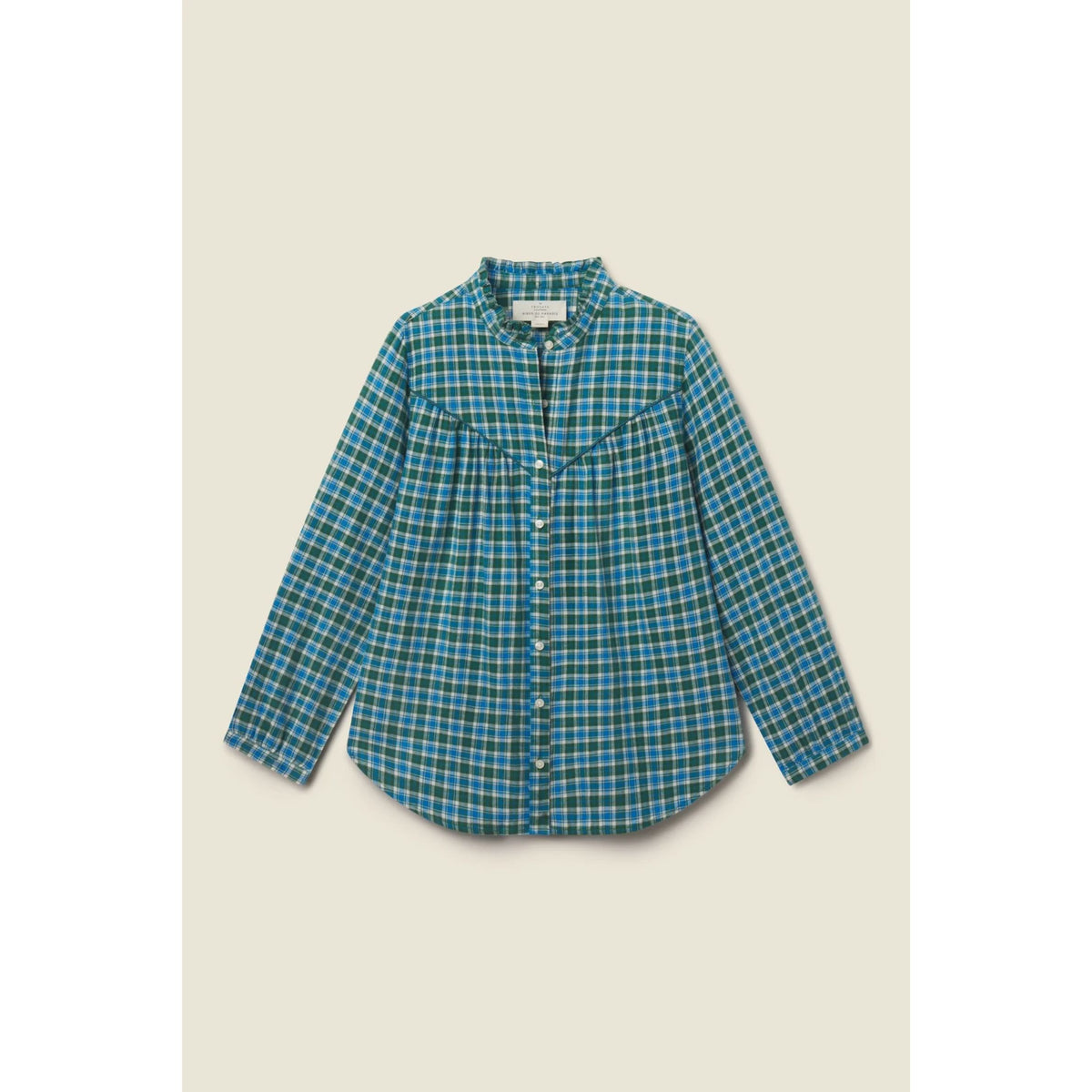 A long-sleeve button-up shirt with a blue and green plaid pattern, featuring a western-style chest pocket with a pointed yoke, laid flat against a light beige background.