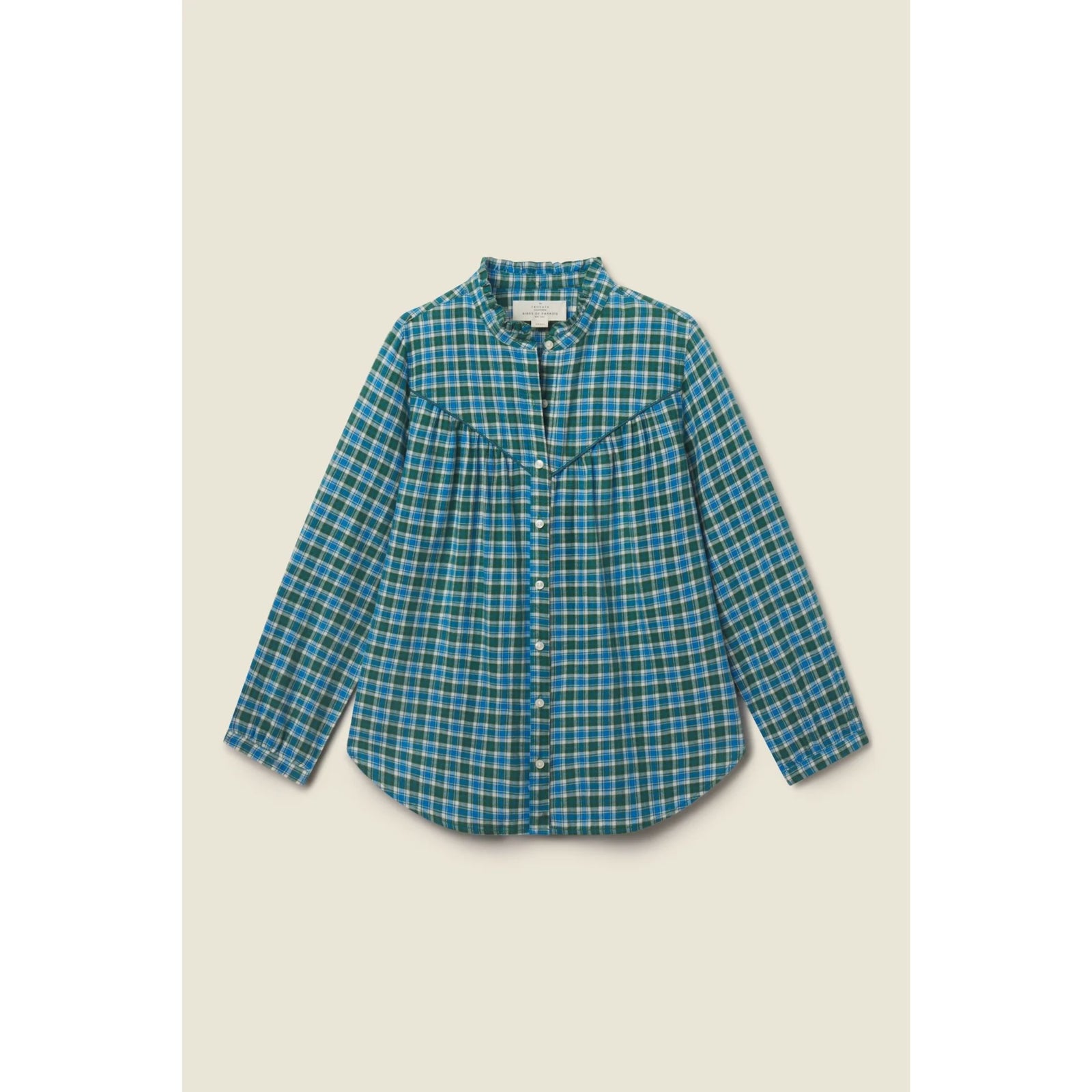 A long-sleeve button-up shirt with a blue and green plaid pattern, featuring a western-style chest pocket with a pointed yoke, laid flat against a light beige background.