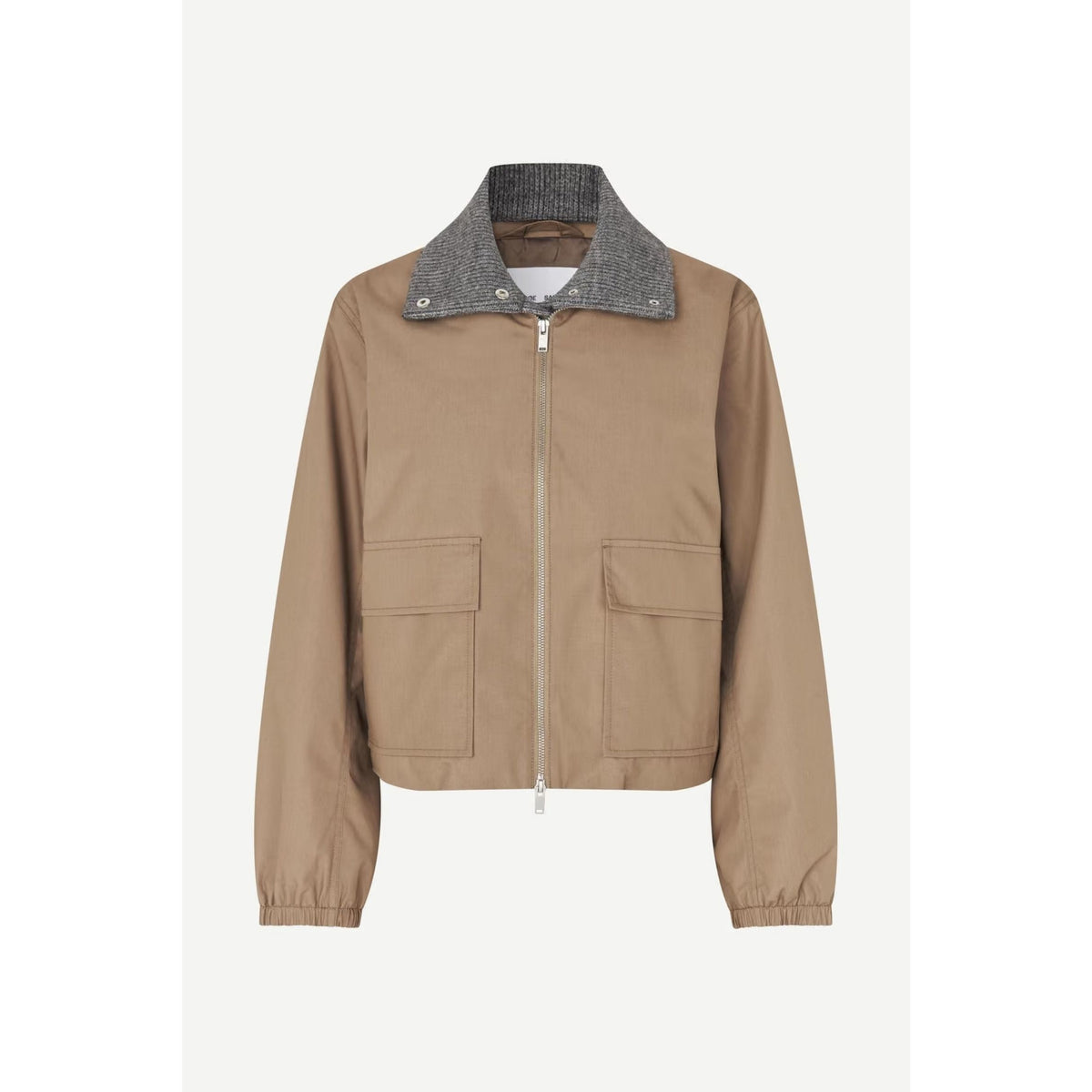 A cropped utility jacket in tan canvas with a contrasting gray textured knit collar, front zipper, and two large flap pockets, shown on a light gray background.