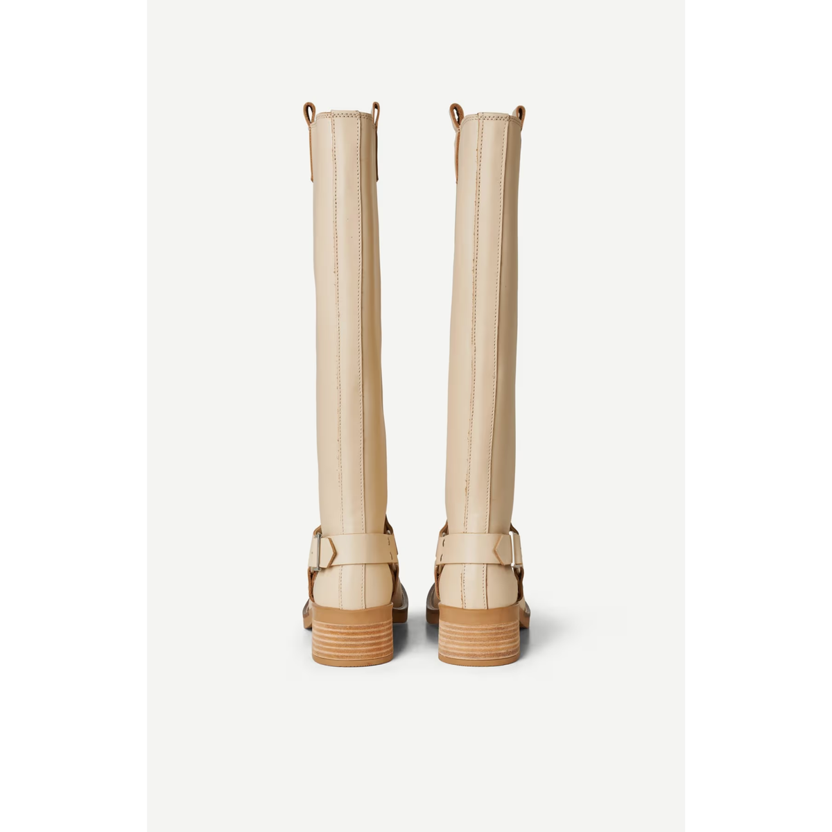A pair of beige leather knee-high boots with brown stacked wooden-look soles and buckle straps, shown from the back against a light gray background.