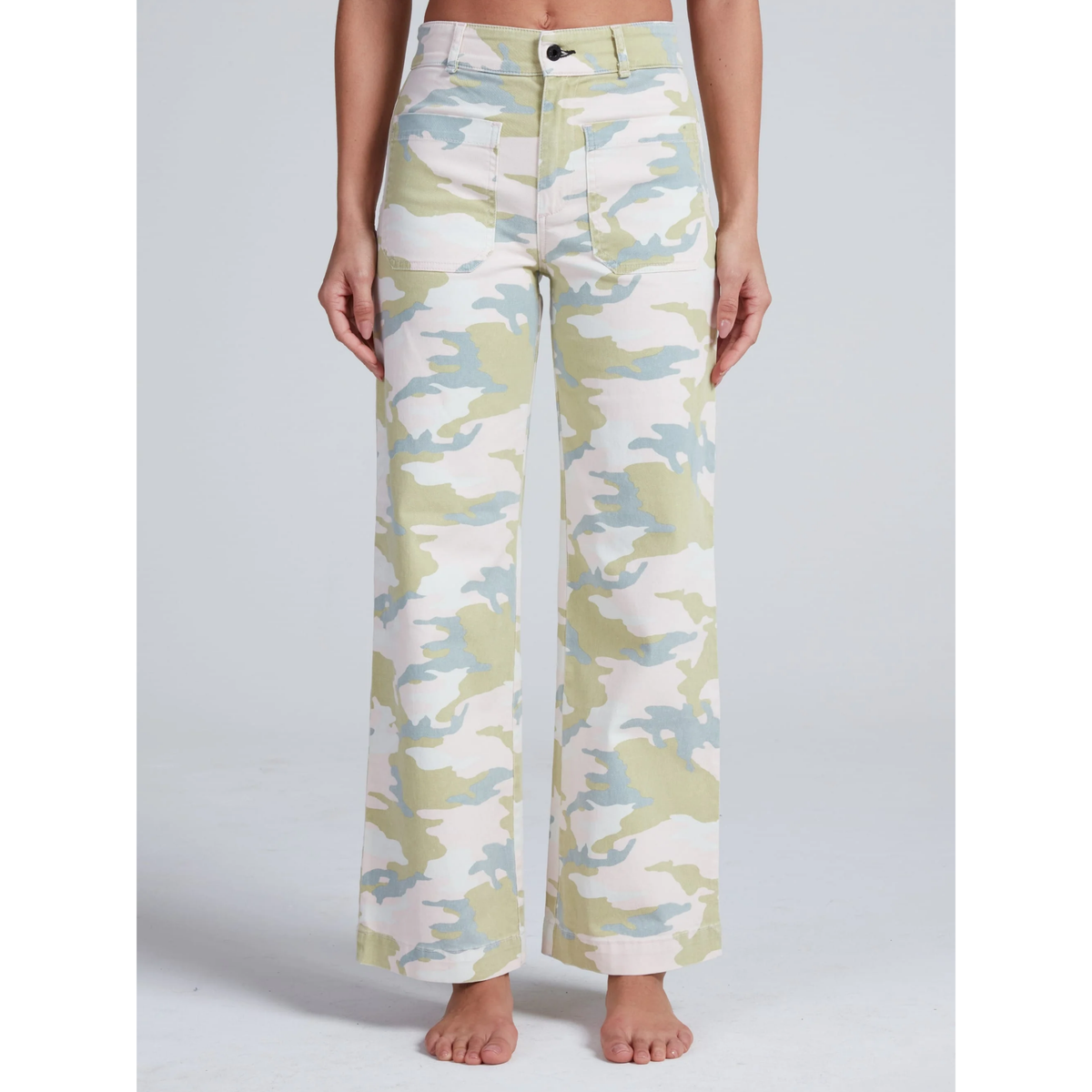 Camouflage-patterned pants worn by a person on a plain background