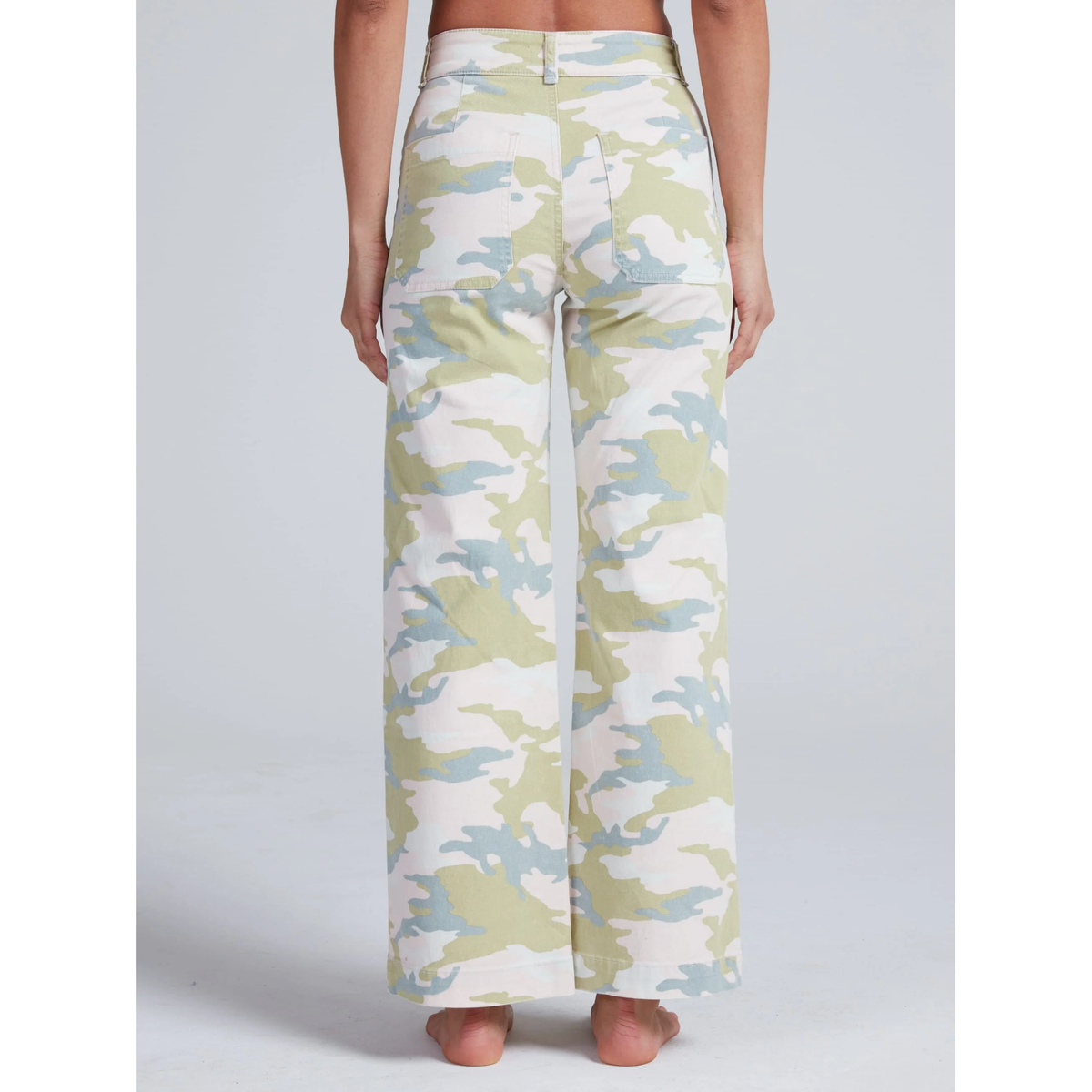 Camouflage-patterned pants worn by a person on a plain background