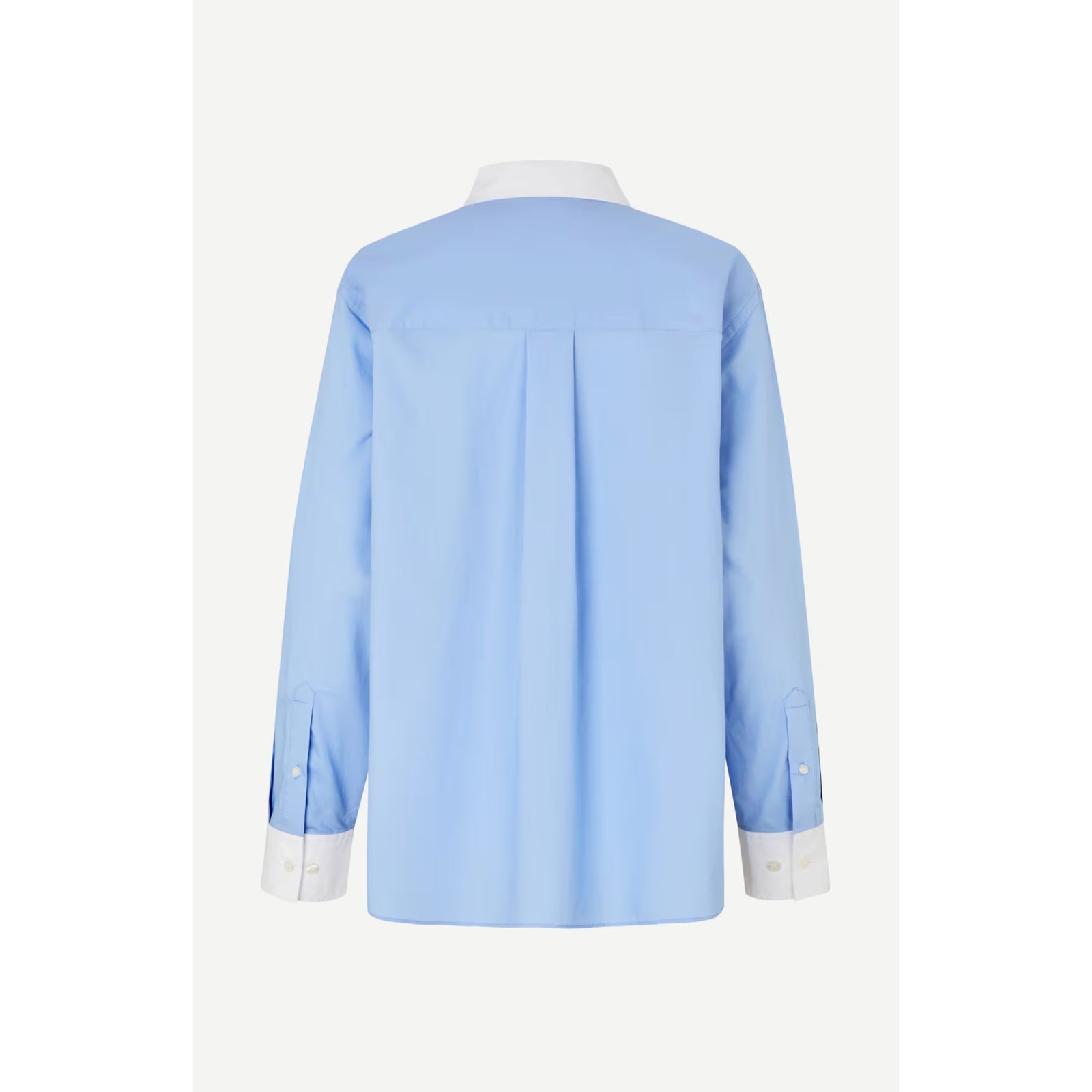 A light blue long-sleeve button-up shirt with a contrasting white collar, cuffs, and front buttons, displayed on a neutral light gray background.
