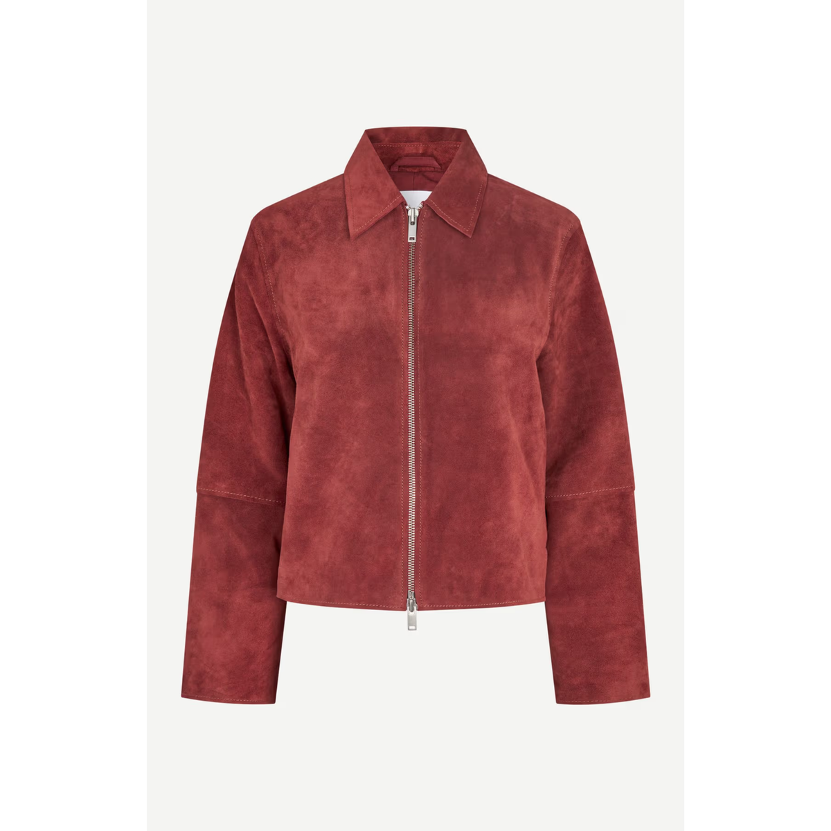 A cropped suede jacket in a dusty rose red color, featuring a full front zipper, a pointed collar, and long sleeves, shown against a light gray background.