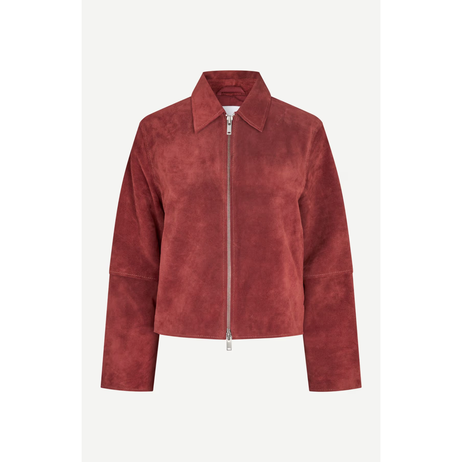 A cropped suede jacket in a dusty rose red color, featuring a full front zipper, a pointed collar, and long sleeves, shown against a light gray background.