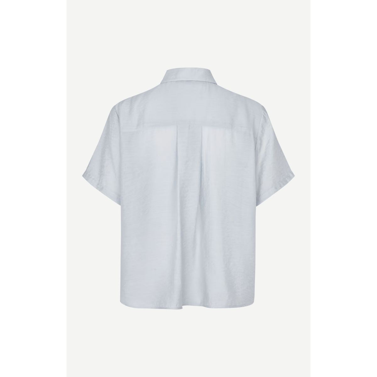A light blue short-sleeve button-up shirt shown from the back, featuring a collar and a subtle vertical pleat detail at the center back, displayed against a light off-white background.