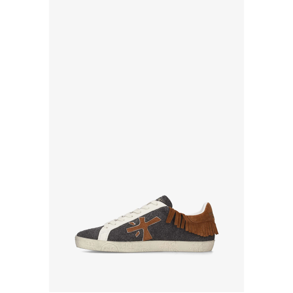 A single low-top sneaker shown in profile against a plain white background. The shoe has a dark gray textured canvas upper, a white leather side panel and laces, a brown suede heel tab with fringe, and a brown cross-shaped logo on the side.
