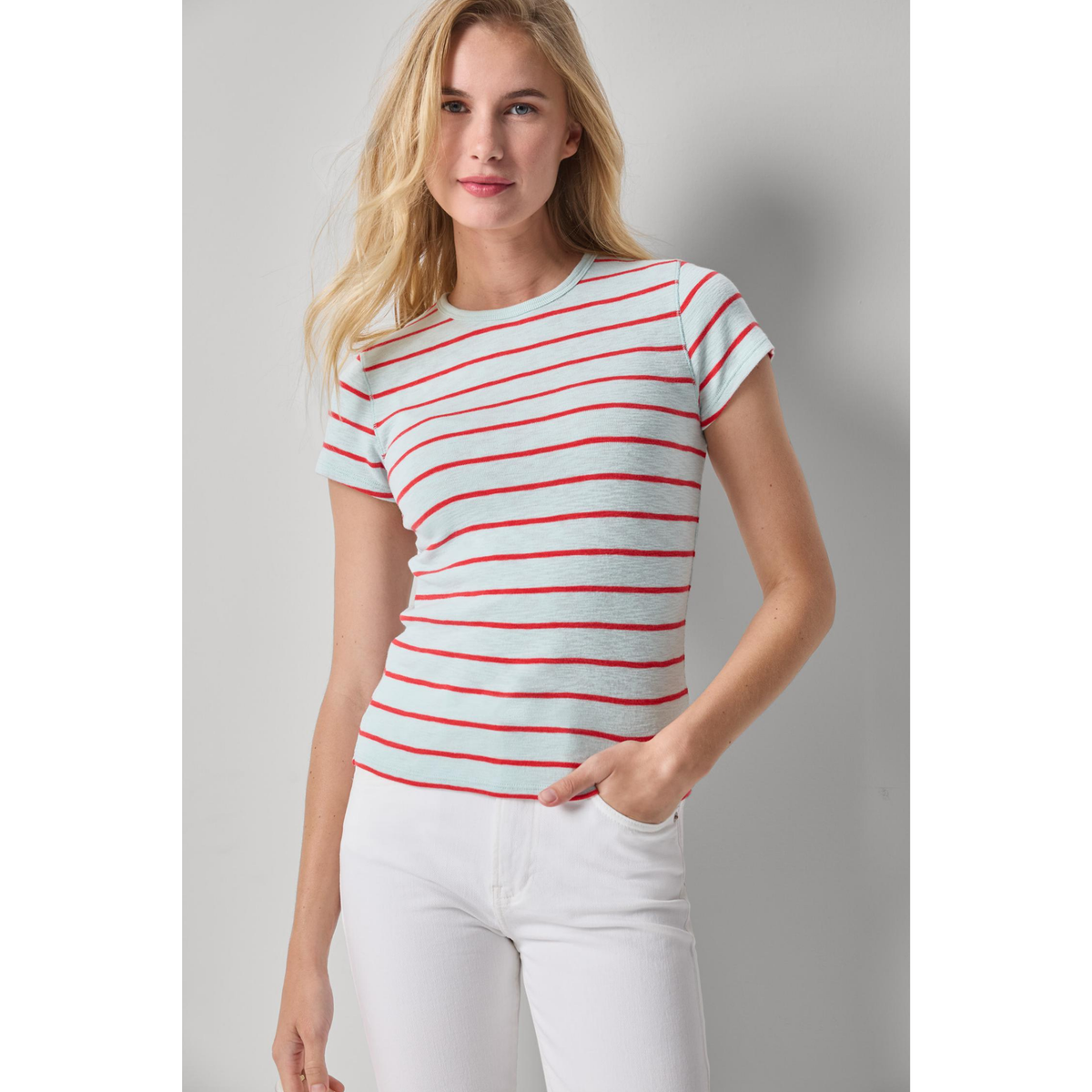 Woman wearing a red and white striped shirt against a plain background