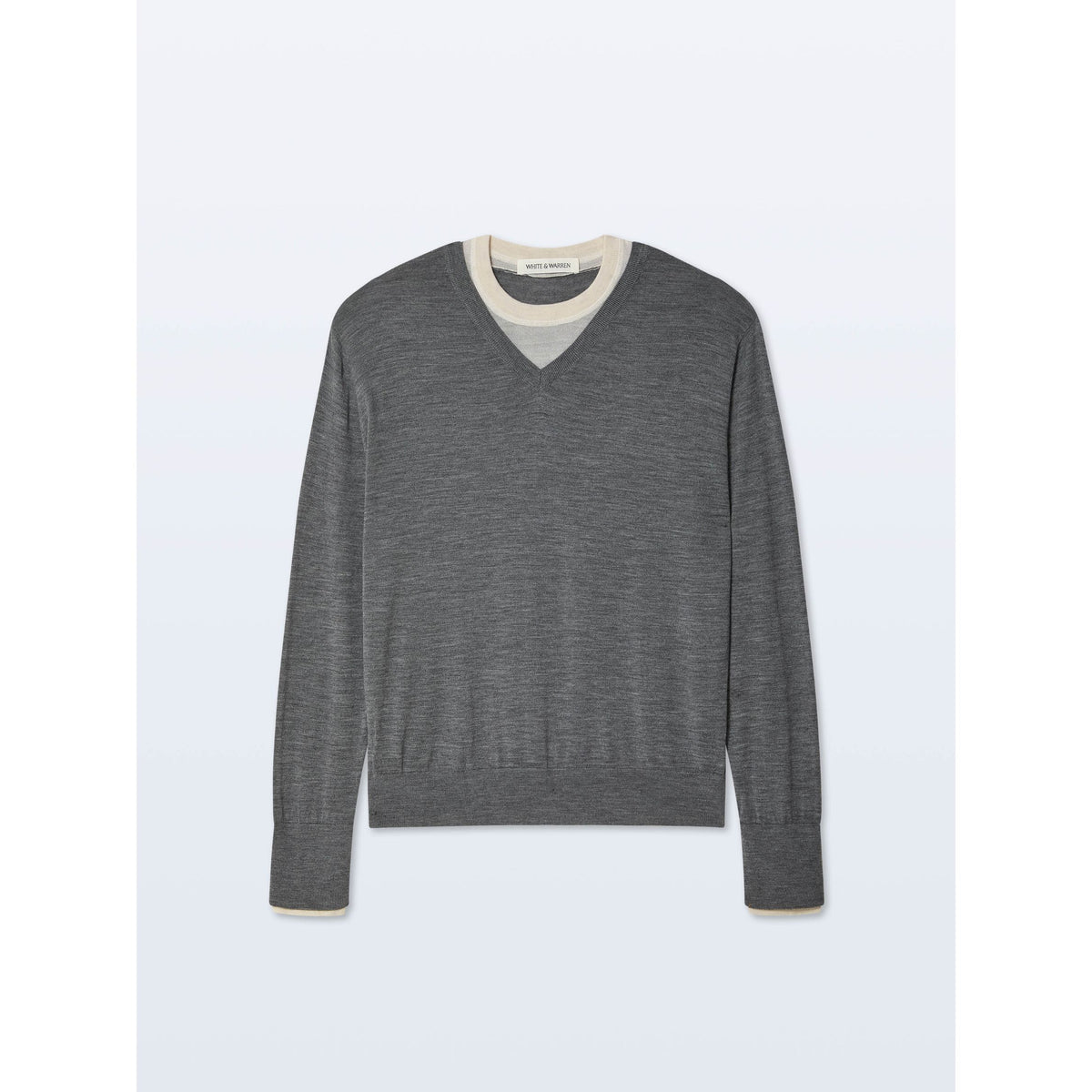 Front flat lay view of the layered v-neck sweater in grey with a white contrast crewneck lining.