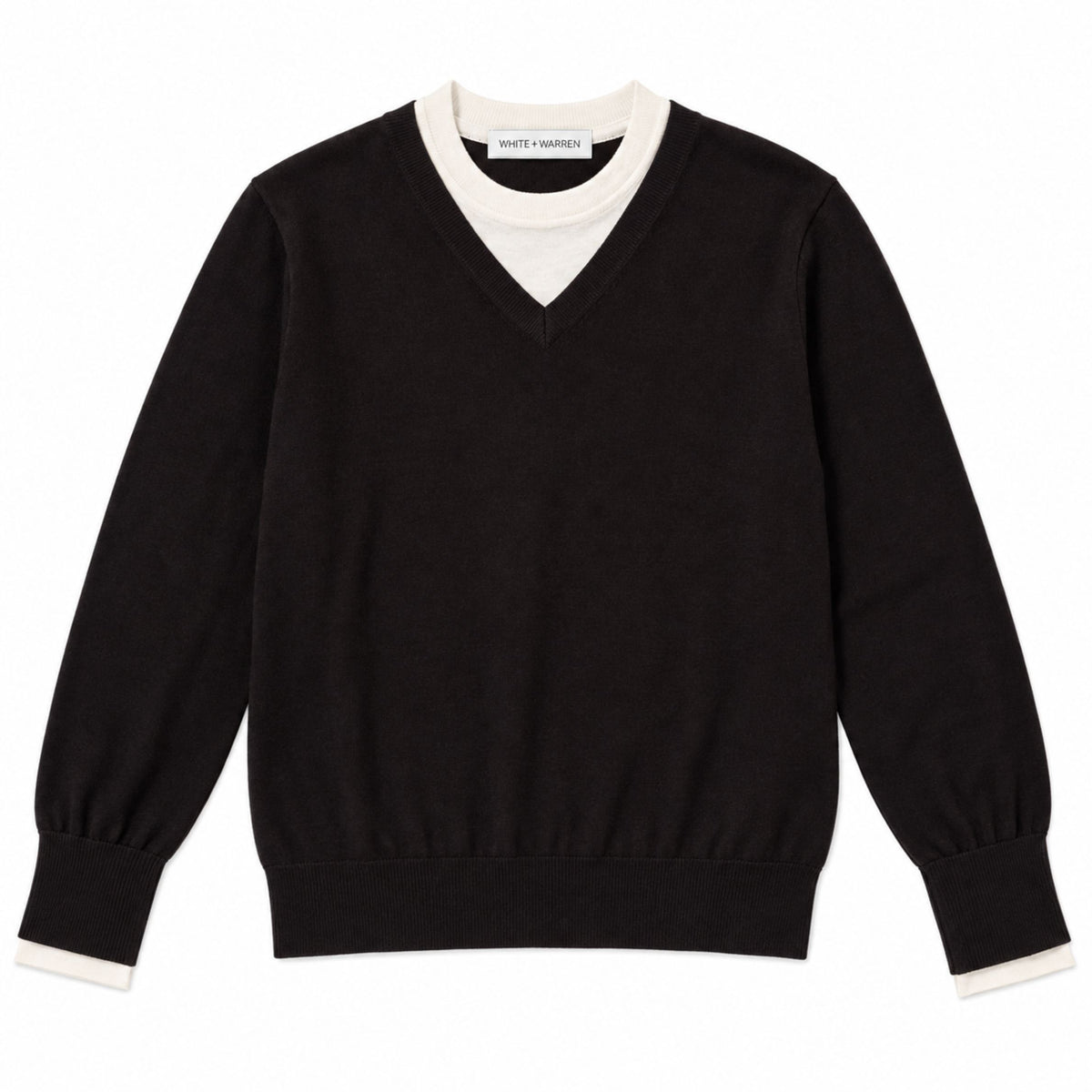 Front flat lay view of the layered v-neck sweater in black with a white contrast neckline and cuffs.