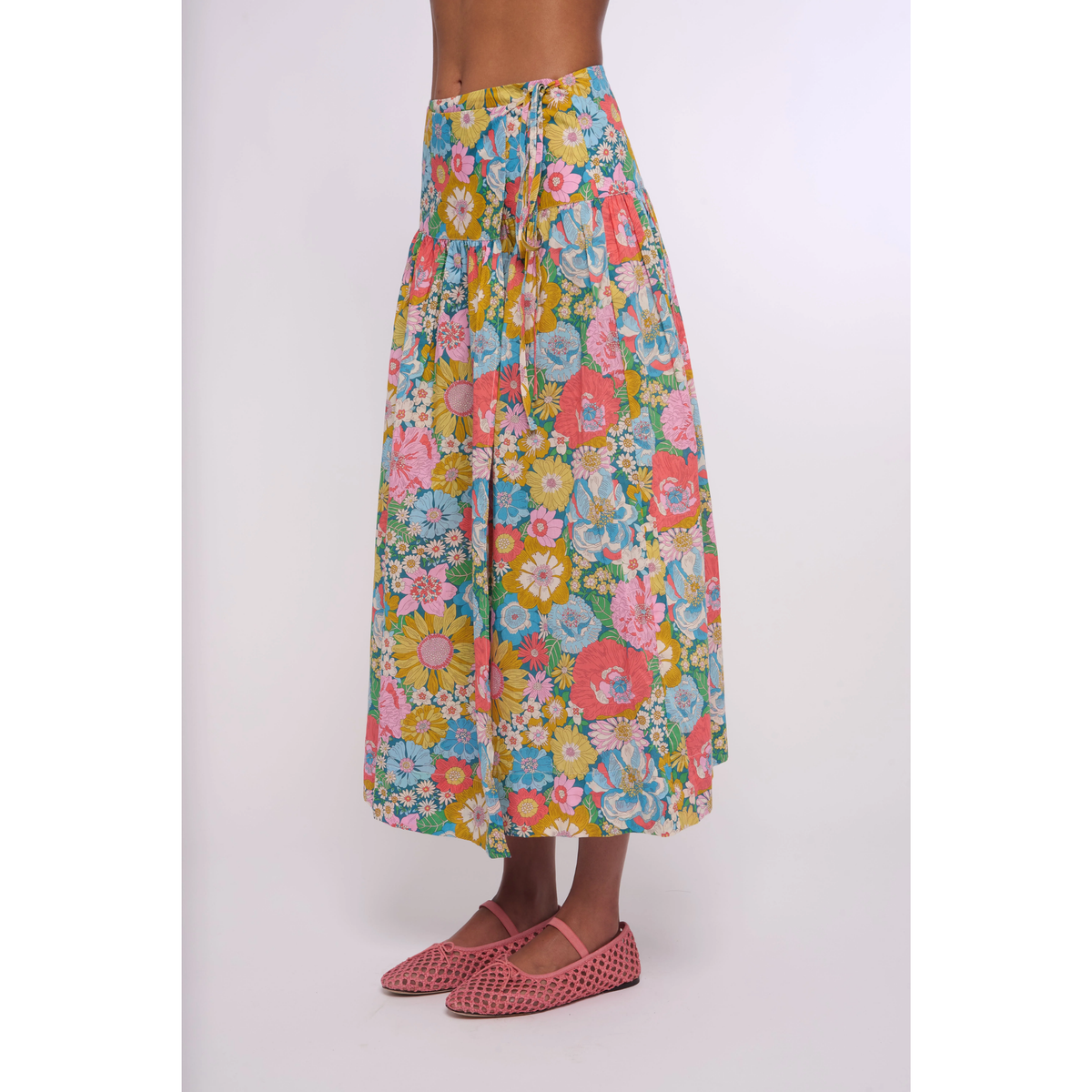 Floral skirt worn by a person on a white background