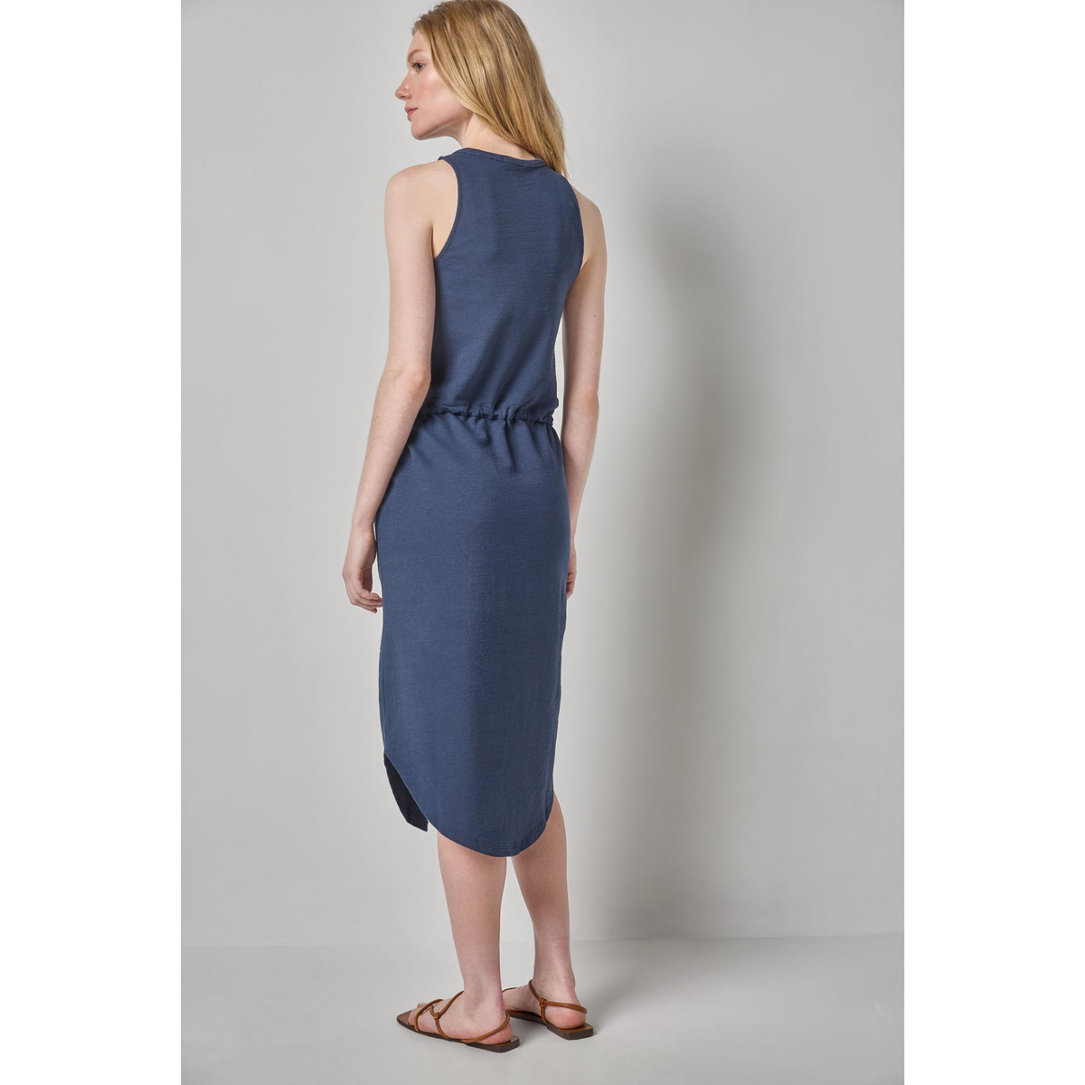 Woman wearing a blue dress against a plain background