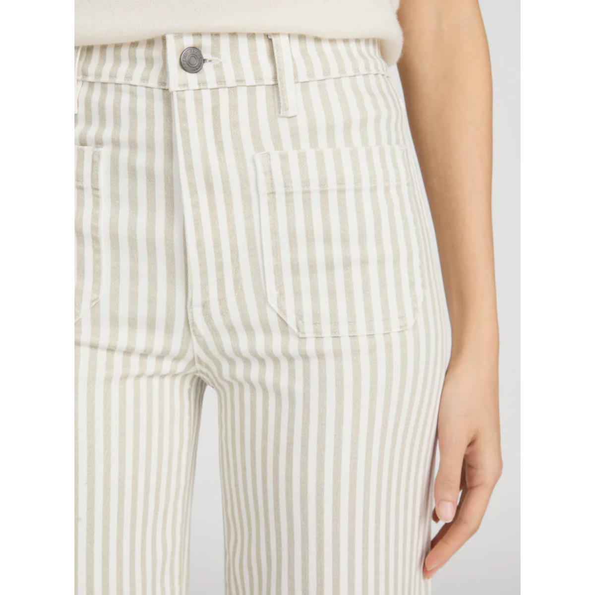 Close-up of a person wearing striped pants with a neutral background