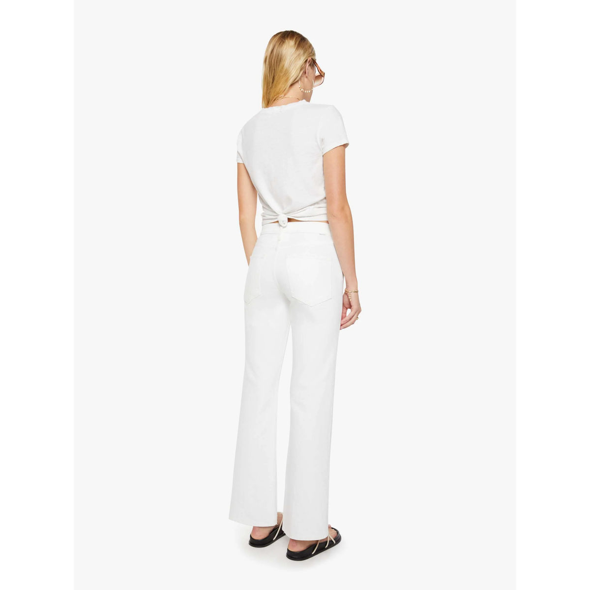 Woman wearing a white jumpsuit on a white background